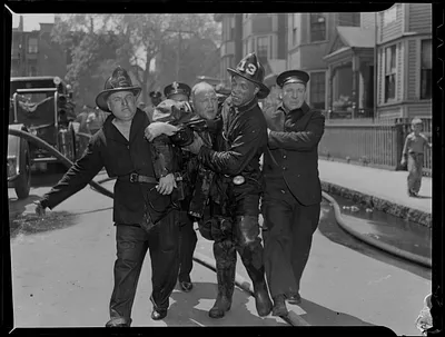 Fire officials carrying a man in distress
