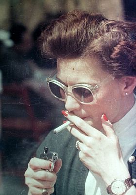 Fashionable Woman Lighting a Cigarette