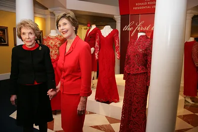 Mrs. Laura Bush and Mrs. Nancy Reagan Pose for a Photo During a Tour of the Red Dress Exhibit at the Ronald Reagan Presidential Library and Museum
