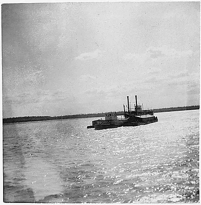 Tugboat pulling a steamer.
