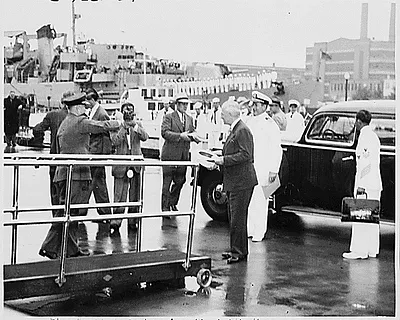 Photograph of President Truman preparing to board his yacht, the U.S.S. WILLIAMSBURG, at Pier 1 of the Naval Gun Factory in Washington, at the beginning of his eighteen-day vacation cruise to Bermuda