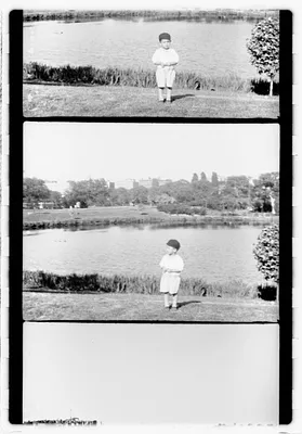 Unidentified boy in front of a body of water by the Museum of Fine Arts, Boston