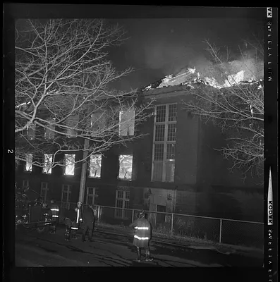 Firefighters looking up at building on fire
