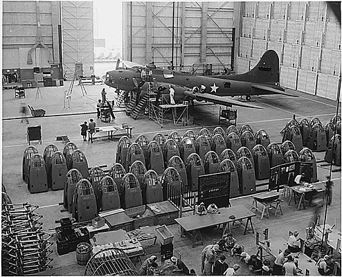 A completed B-17 F heavy bomber is checked by final inspectors at the Long Beach, Calif., plant of Douglas Aircraft Company before it moves to the flight line for rigid acceptance tests.