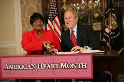 President George W. Bush Shakes the Hand of Joyce Cullen, a Heart Disease Survivor, After Signing a Presidential Proclamation in Honor of American Heart Month in Kansas City