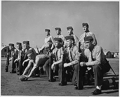 Eleven football players who have gained national recognition on the gridiron are now undergoing Marine Corps training at Parris Island,SC. They are left to right, Tommy Davis, Duke; Mike Micka, Colgate; Bert Gianelli, Coll. of Pacific; Elmer Jones, Franklin and Marshall; Alex Agase, Purdue; Pat Preston, Duke; Ralph Heywood, USC; (Backfield) Angelo Bertelli, Notre Dame; John Podesto, Coll. of Pacific; Tony Butkovich, Purdue; Mickey McCardle, USC.