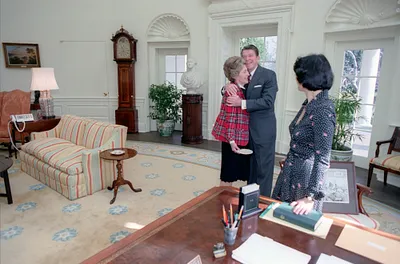President Ronald Reagan hugging Nancy Reagan in the Oval Office on his 70th birthday