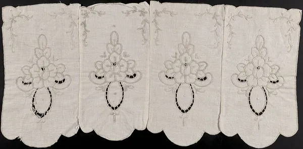 Embroidered scalloped textile with cut outs