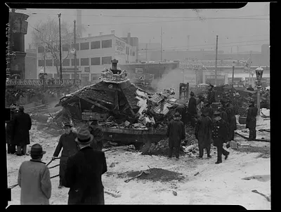 Firefighter crews gather around a collapsed building