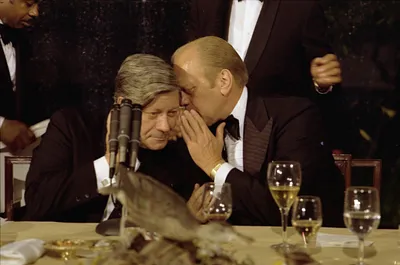 President Gerald R. Ford Speaking Directly Into the Ear of Chancellor Helmut Schmidt of the Federal Republic of Germany following the Toasts at a State Dinner Honoring Chancellor Schmidt