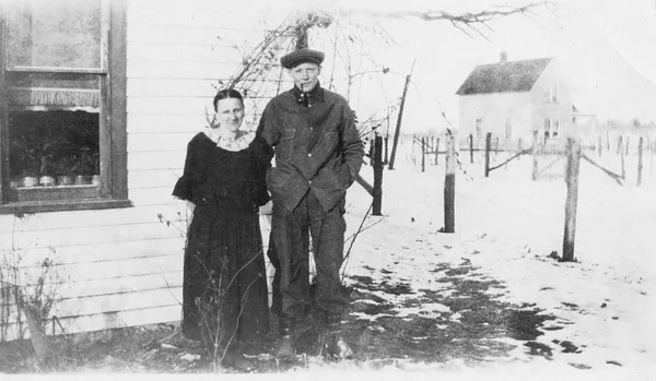 Couple Outside House, IA, 1910