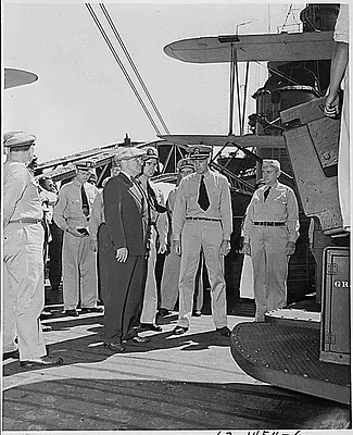 On his tour of the U. S. S. Augusta, President Harry S. Truman stopped to talk to Lt. Commander S. H. Graham, Jr. in front of one of the anti-aircraft guns. President Truman is en route to the Potsdam Conference in Germany.
