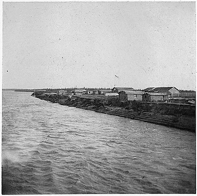 View of buildings along a river. A town?