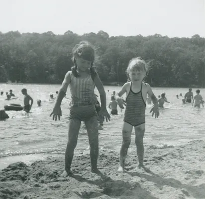 Beth and Becky McKinley covered in sand, 1966