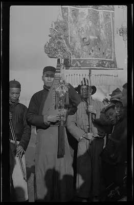 Musicians in procession near College to drive out evil spirits and bestow blessings and protection