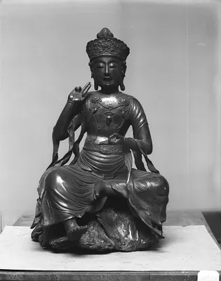 Buddha seated on gnarled tree-trunk base