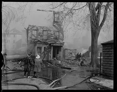 Firefighters looking at the Castle Novelty Co, Inc. building