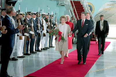 President Ronald Reagan and Nancy Reagan (holding flowers) Attend the Arrival Ceremony at Andrews Air Force Base