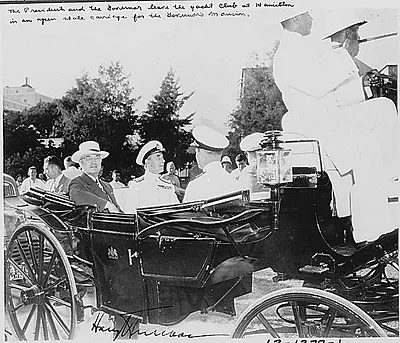 Photograph taken during the vacation cruise of President Harry S. Truman to Bermuda. The President and the Governor of Bermuda, Sir Ralph Leatham, are in a carriage leaving the yacht club at Hamilton for the Governor's mansion.