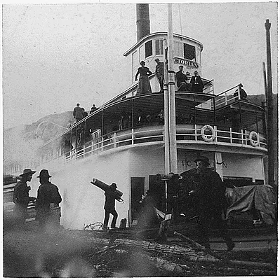 Steamer "Victorian" in port. People on deck and on the dock..